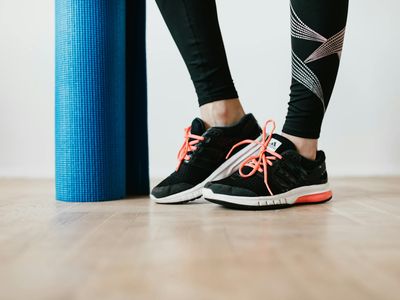 Close-up of athletic shoes on a yoga mat.